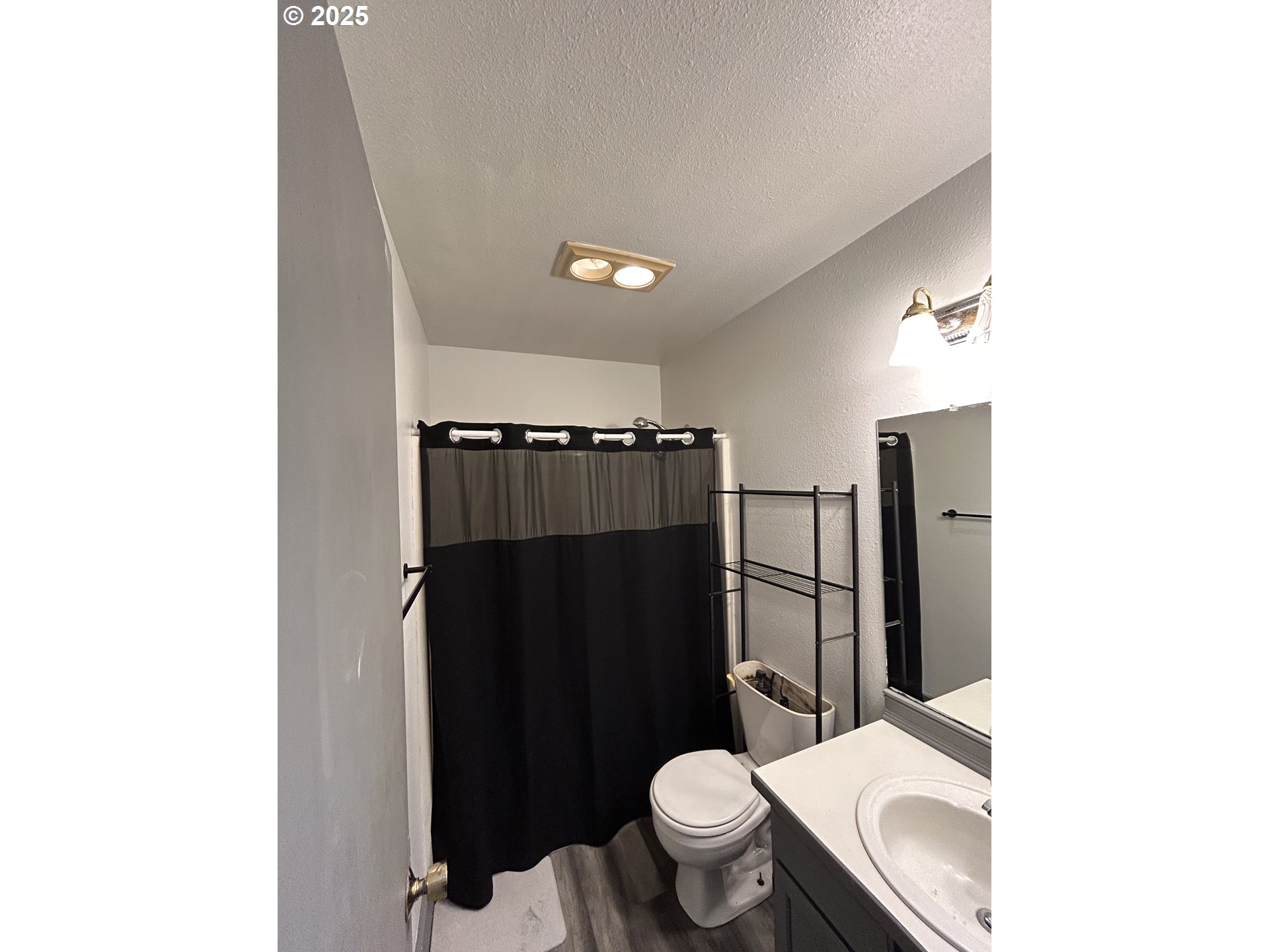 4195 Daisy Street Springfield, OR 97478 - Photo 13 of 20 a bathroom with a toilet a sink and shower