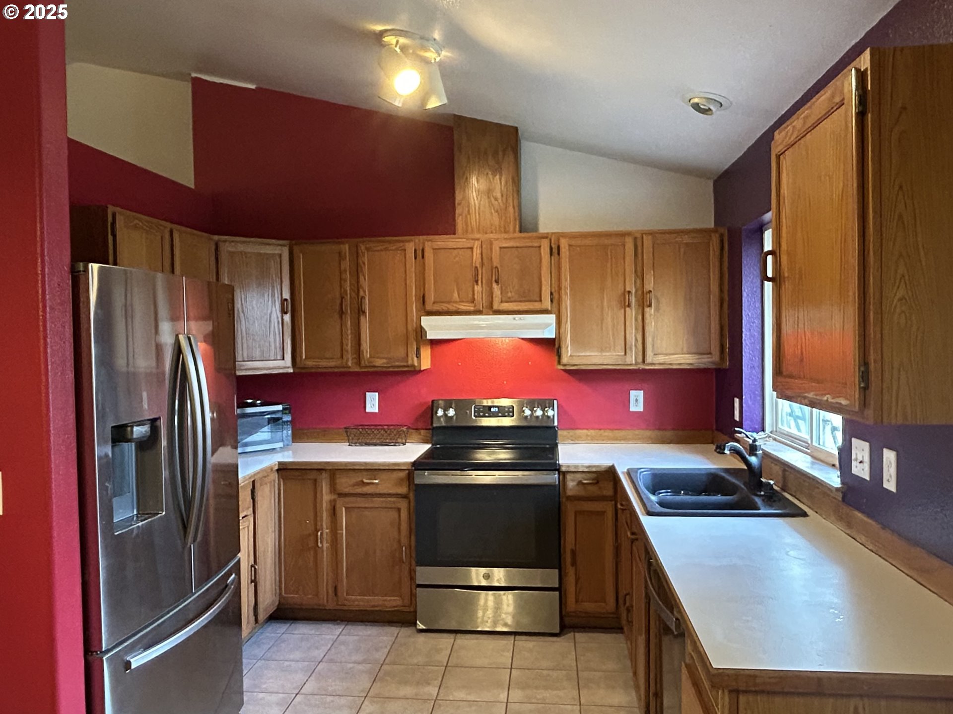 4195 Daisy Street Springfield, OR 97478 - Photo 5 of 20 a kitchen with a stove a refrigerator and a sink