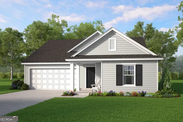 a front view of a house with a yard and trees