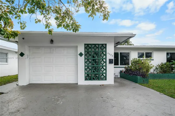 a view of a house with a yard and garage