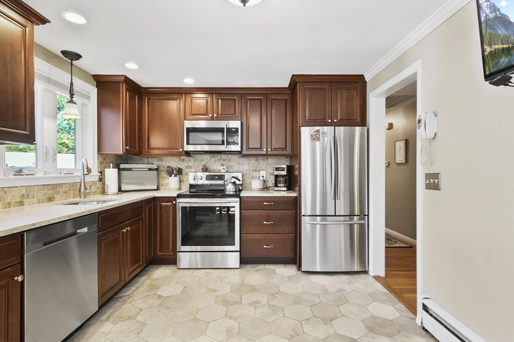 35 Blackman Road Canton, MA 02021 - Photo 7 of 26 a kitchen with stainless steel appliances granite countertop a refrigerator stove a sink and a microwave