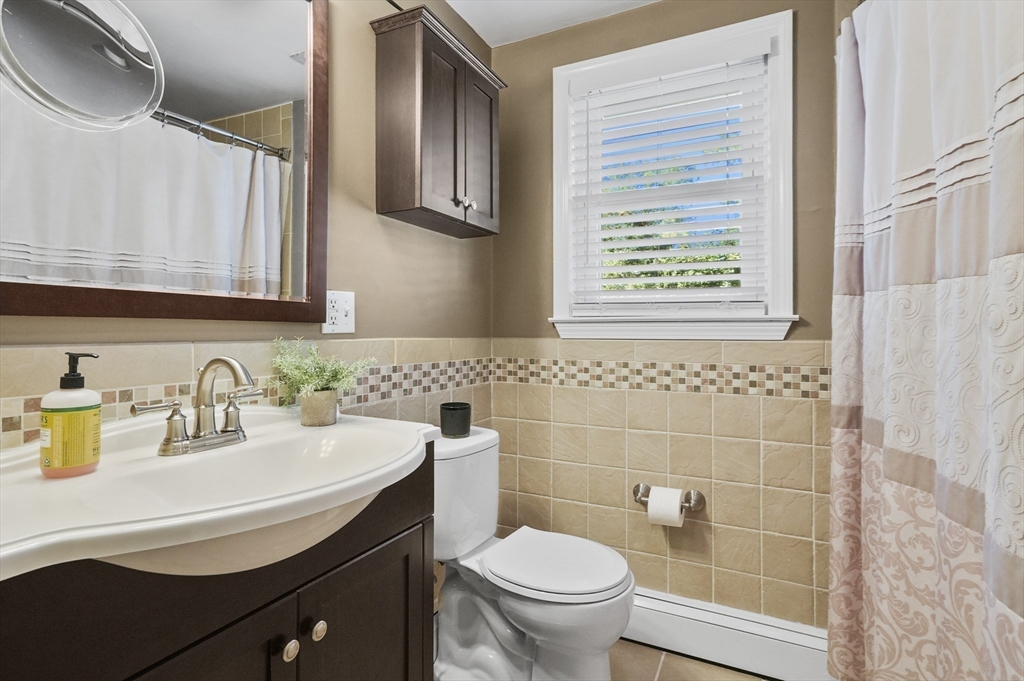 35 Blackman Road Canton, MA 02021 - Photo 8 of 26 a bathroom with a sink a toilet and a mirror