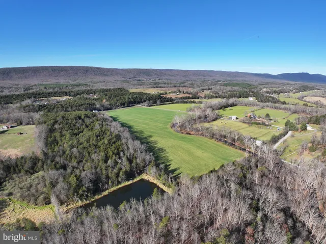 an aerial view of a houses with a yard
