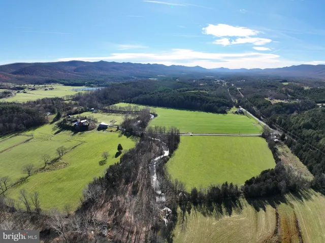a view of a lush green hillside and mountains