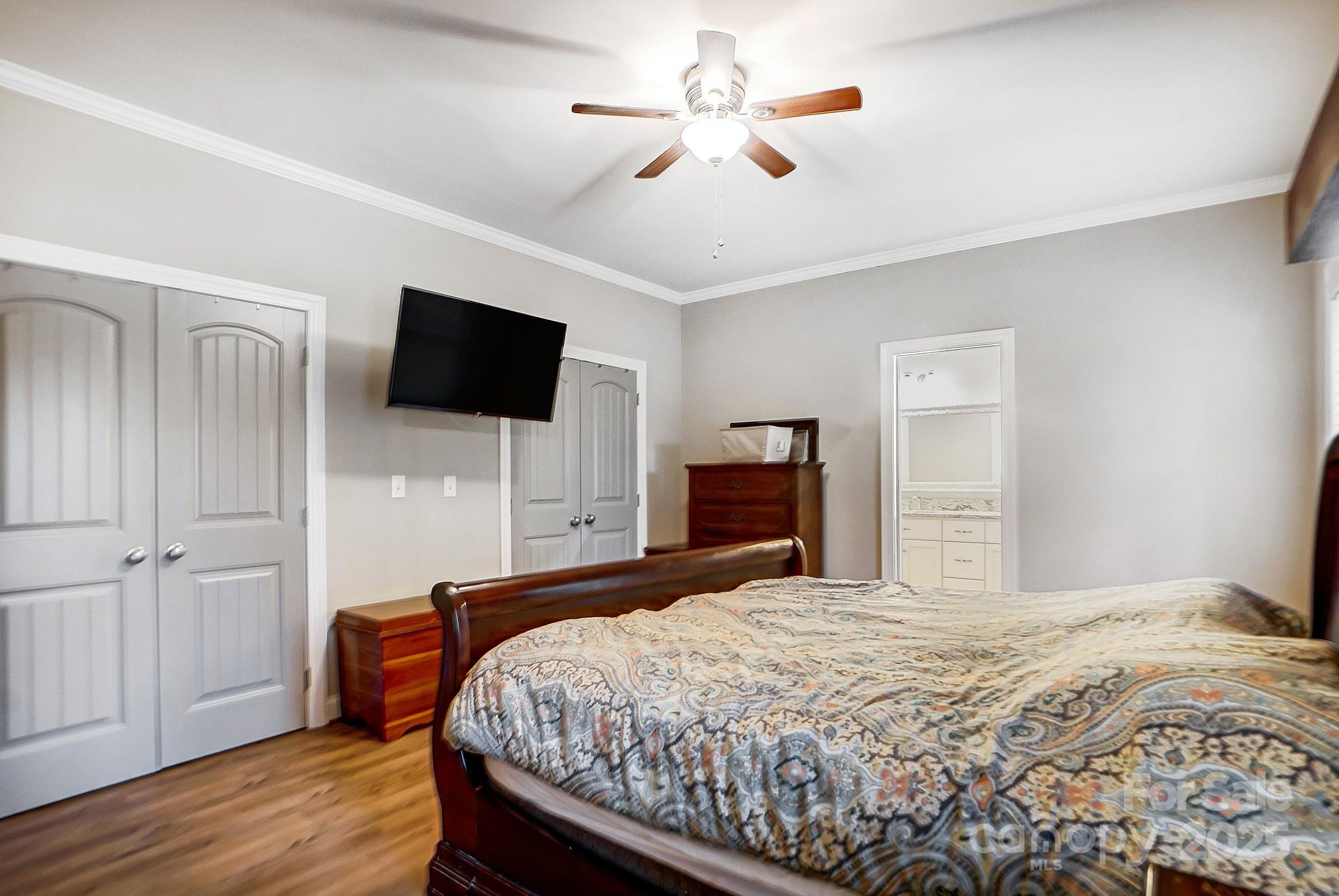 125 Jefferson Drive Locust, NC 28097 - Photo 16 of 27 a bedroom with a bed and a flat screen tv