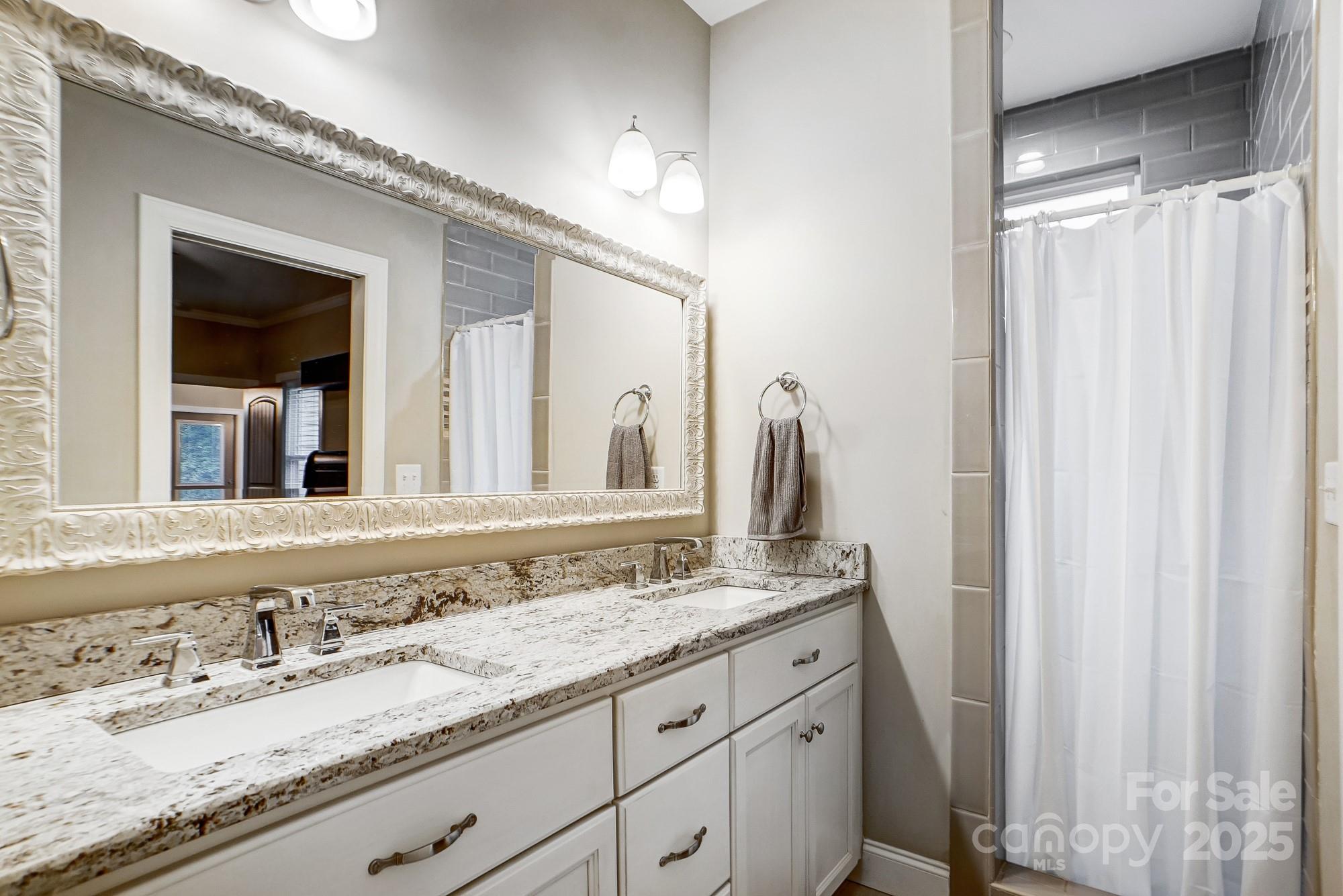 125 Jefferson Drive Locust, NC 28097 - Photo 19 of 27 a bathroom with a granite countertop sink and a mirror