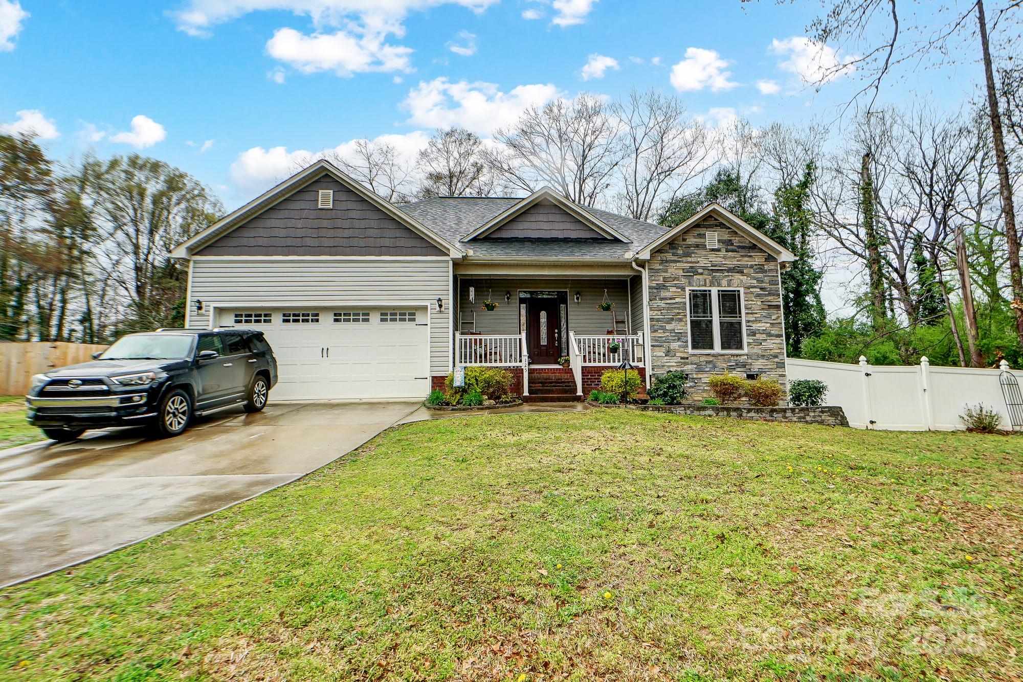 125 Jefferson Drive Locust, NC 28097 - Photo 2 of 27 a front view of a house with garden