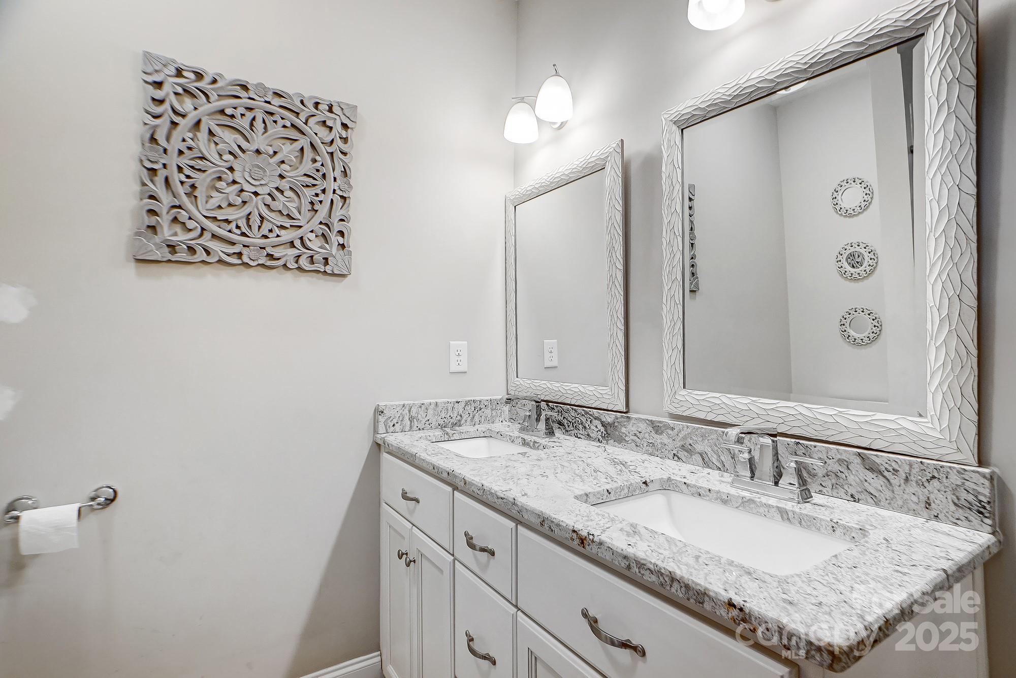125 Jefferson Drive Locust, NC 28097 - Photo 22 of 27 a bathroom with a granite countertop sink and a mirror