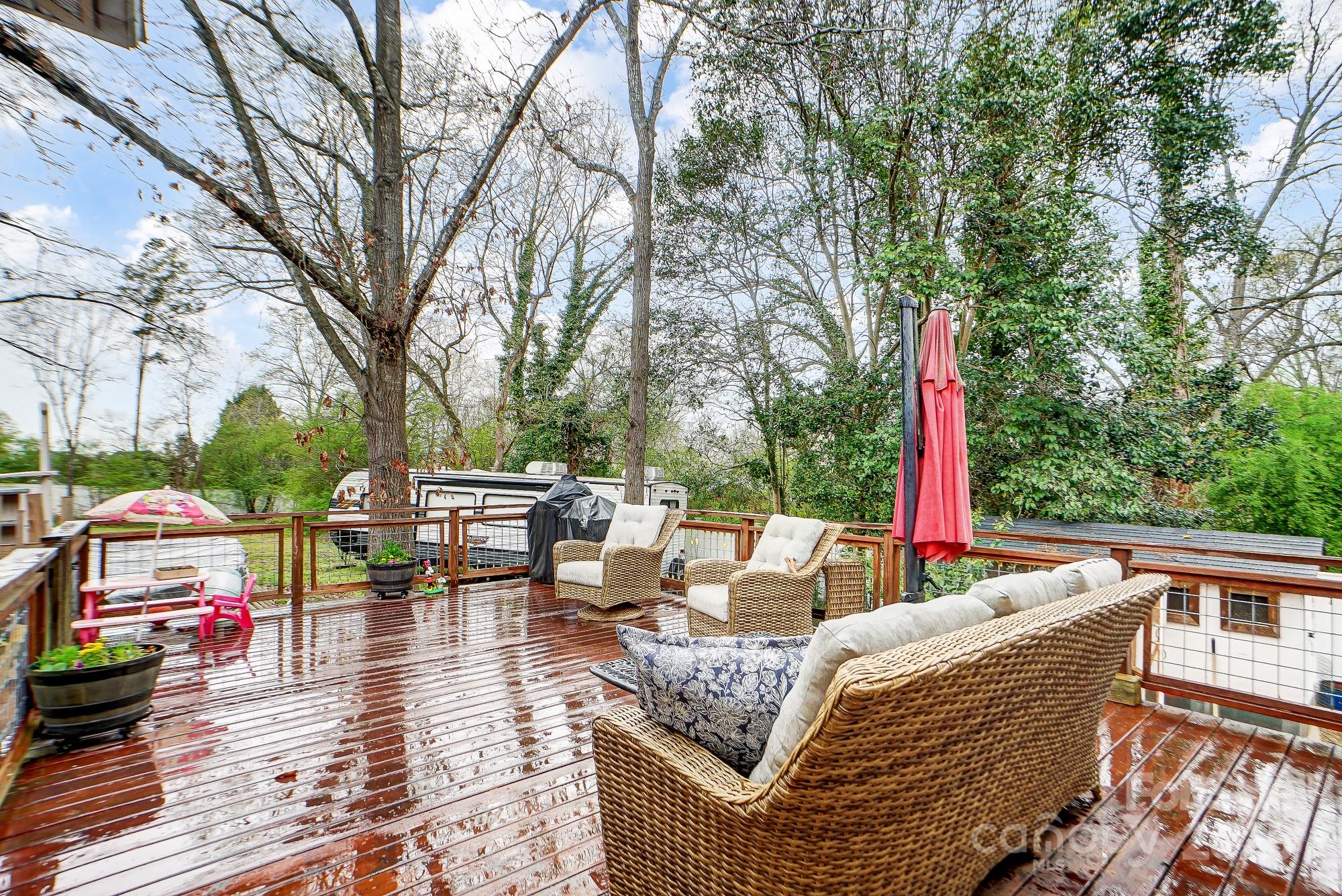 125 Jefferson Drive Locust, NC 28097 - Photo 25 of 27 a roof deck with couches and wooden fence