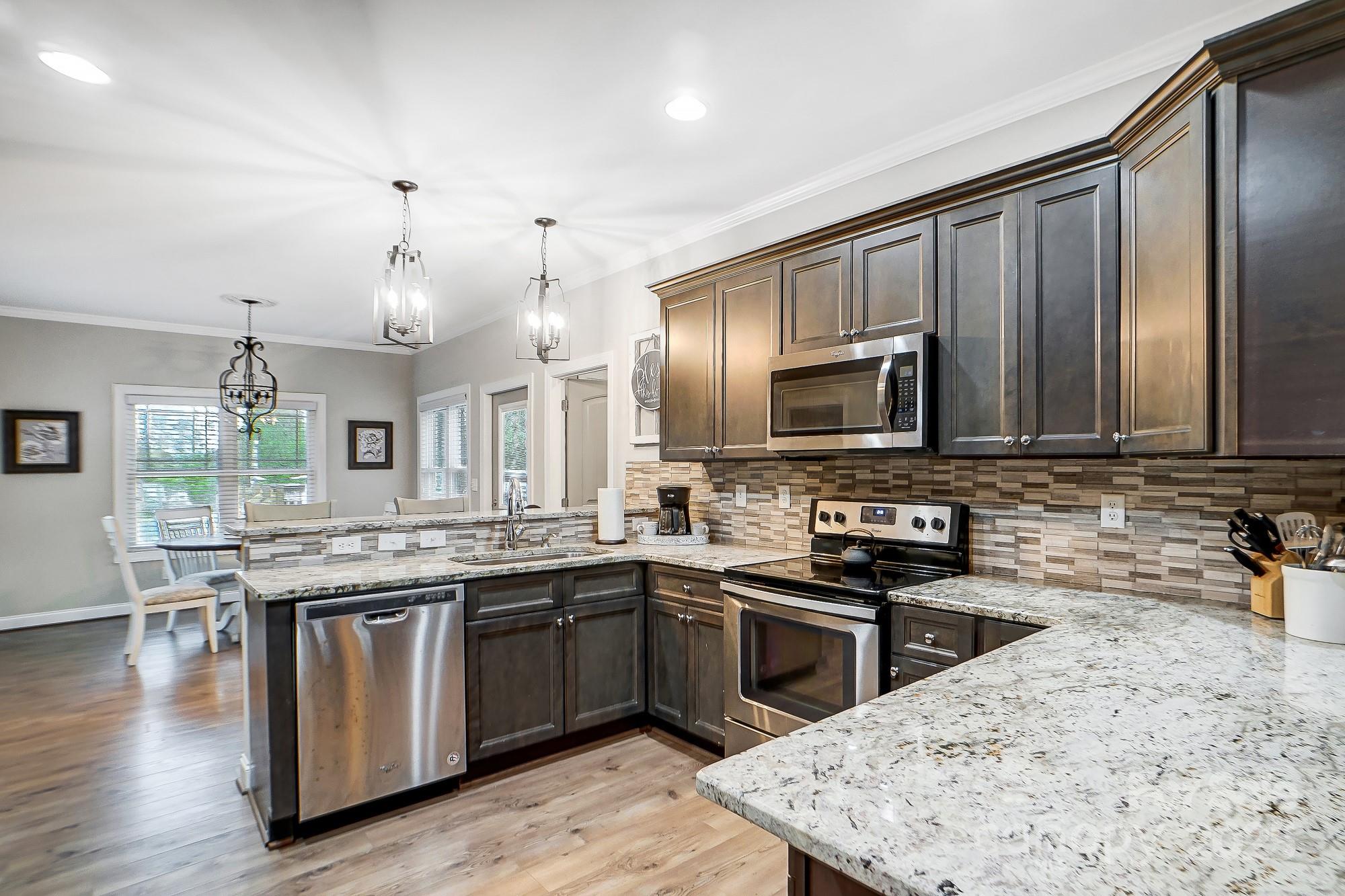 125 Jefferson Drive Locust, NC 28097 - Photo 7 of 27 a kitchen with a sink stove and microwave
