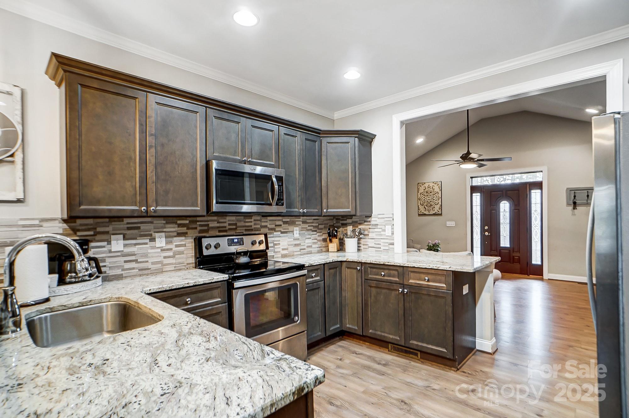 125 Jefferson Drive Locust, NC 28097 - Photo 8 of 27 a kitchen with a sink stove and microwave