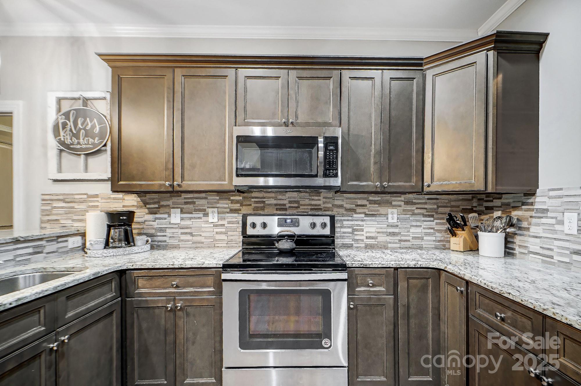 125 Jefferson Drive Locust, NC 28097 - Photo 10 of 27 a kitchen with sink a microwave and cabinets