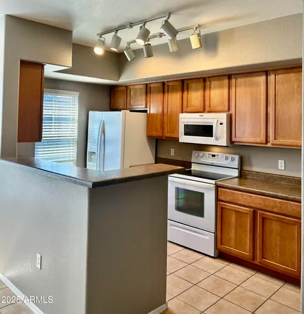 a kitchen with stainless steel appliances a stove sink and microwave