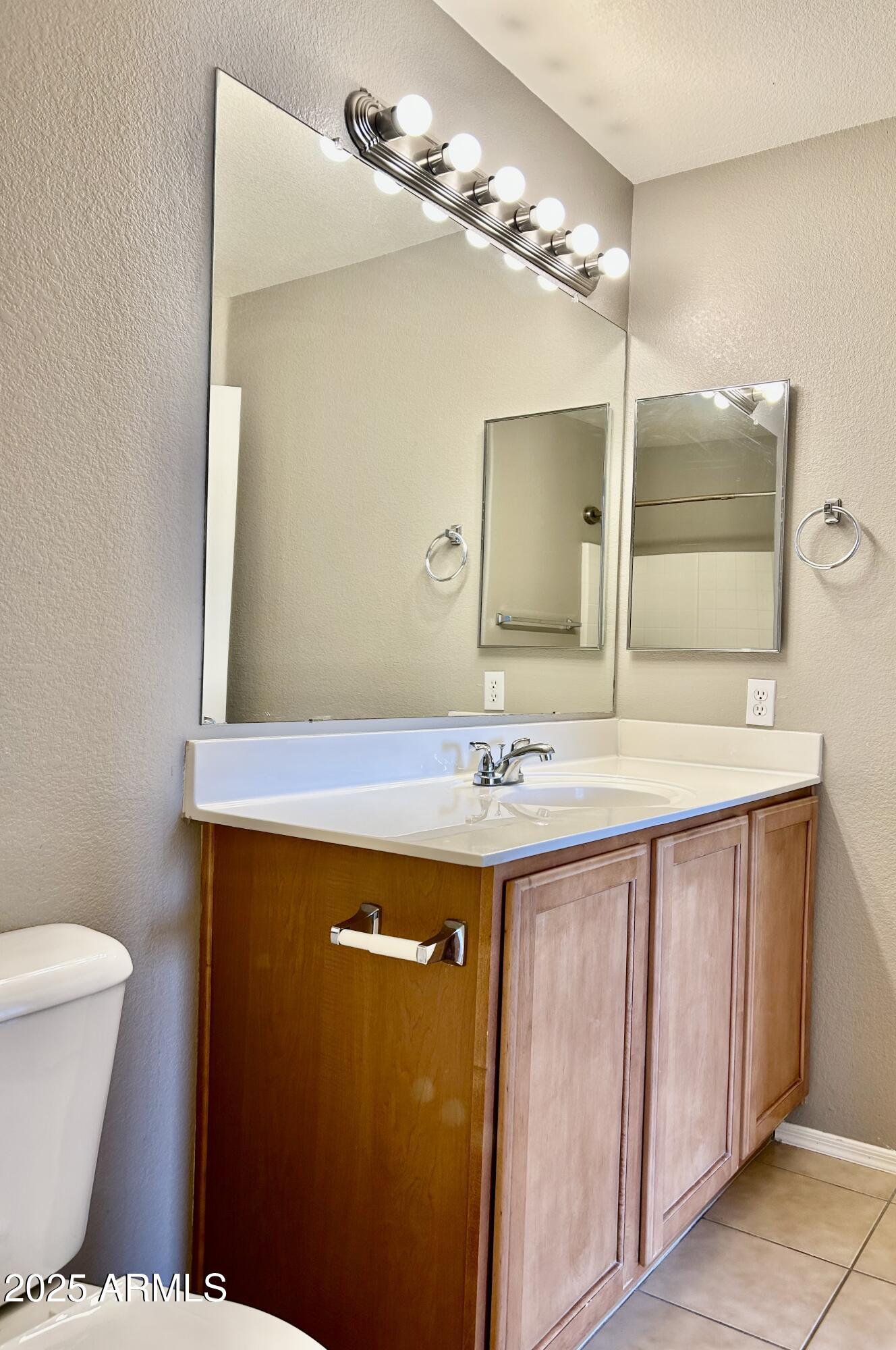 2402 East 5th Street, Unit 1555 Tempe, AZ 85288 - Photo 6 of 12 a bathroom with a sink and a mirror