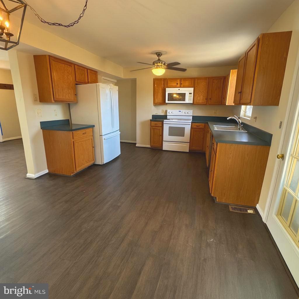 58 North Gala Littlestown, PA 17340 - Photo 4 of 10 a kitchen with stainless steel appliances wooden floor and a refrigerator