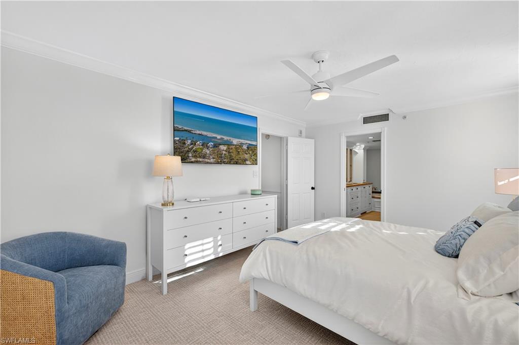 6573 Marissa Loop, Unit 2004 Naples, FL 34108 - Photo 11 of 30 a bedroom with a bed and a dresser