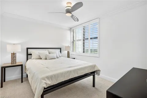 a bedroom with a bed lamp and window