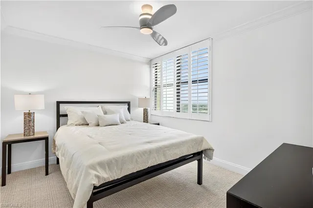 a bedroom with a bed lamp and window