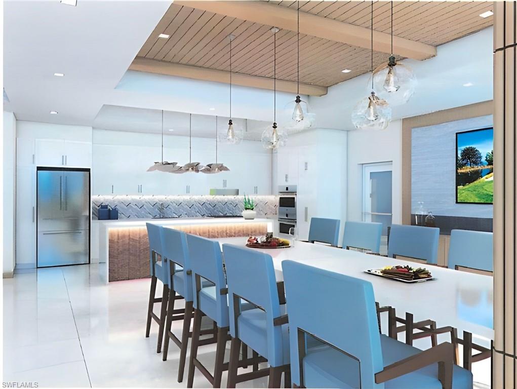 6573 Marissa Loop, Unit 2004 Naples, FL 34108 - Photo 18 of 30 a kitchen with a table and chairs in it