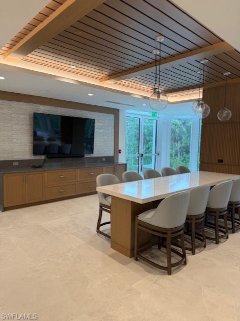 6573 Marissa Loop, Unit 2004 Naples, FL 34108 - Photo 24 of 30 a view of a patio with table and chairs under an umbrella