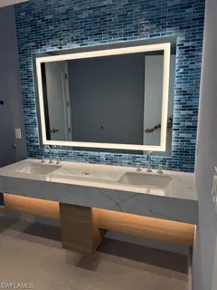 a large kitchen with a large counter top appliances and cabinets