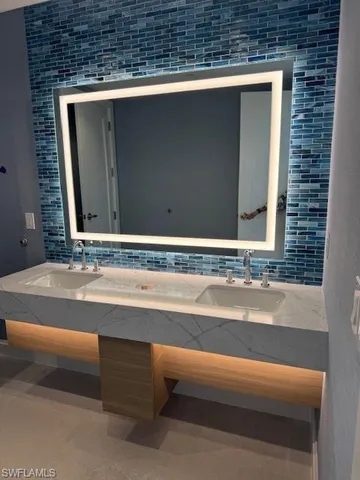 a large kitchen with a large counter top appliances and cabinets