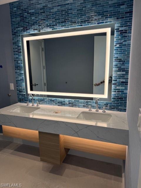 6573 Marissa Loop, Unit 2004 Naples, FL 34108 - Photo 29 of 30 a bathroom with a sink and a mirror