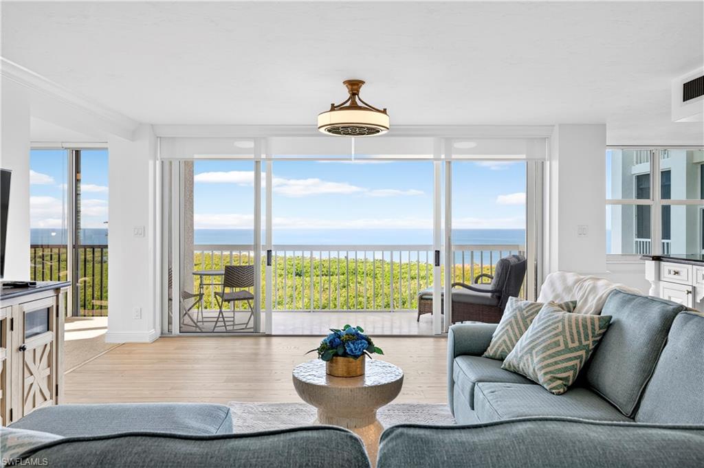 6573 Marissa Loop, Unit 2004 Naples, FL 34108 - Photo 4 of 30 a living room with furniture and a large window