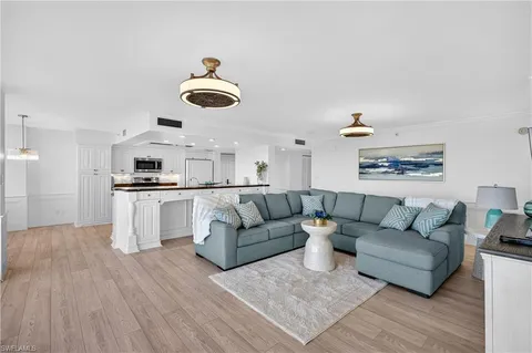 a living room with furniture and kitchen view