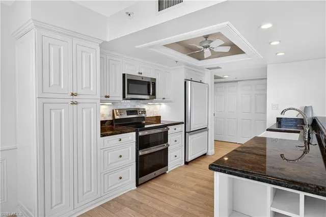 a kitchen with stainless steel appliances granite countertop a lot of counter space and wooden floor