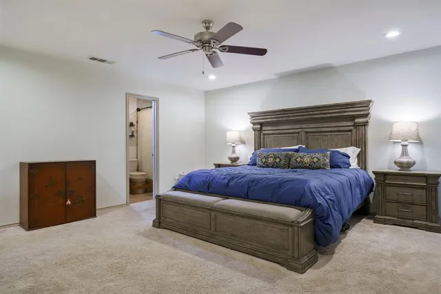 a bedroom with a bed and a ceiling fan