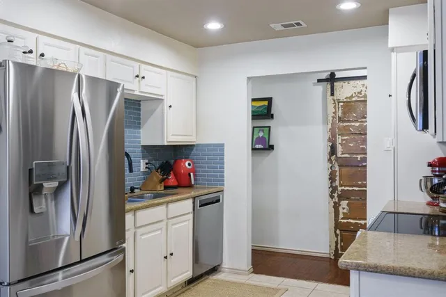 a kitchen with stainless steel appliances a refrigerator and cabinets