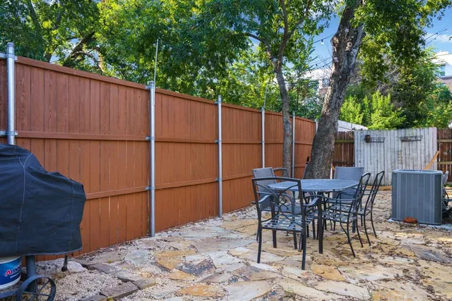 a backyard of a house with table and chairs