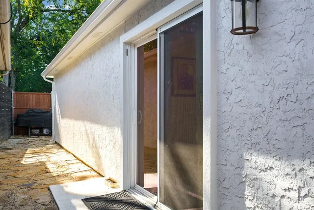 a view of balcony with floor to ceiling window and wooden fence