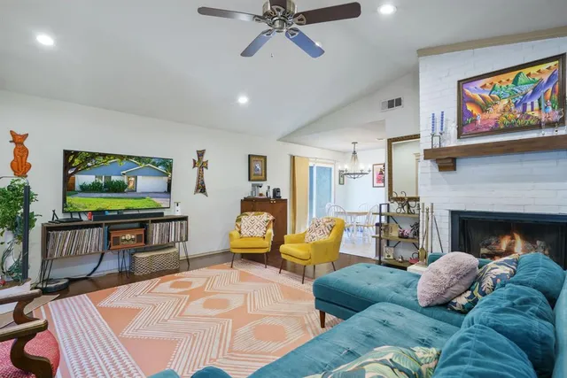 a living room with furniture a flat screen tv and a fireplace