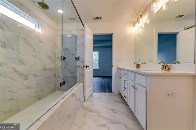 a spacious bathroom with a double vanity sink a mirror and a bathtub