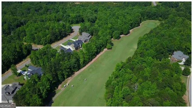an aerial view of a house with a swimming pool outdoor seating and yard
