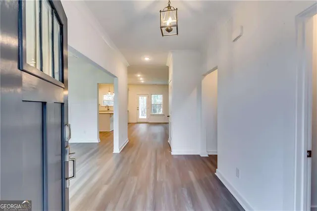 a view of hallway with wooden floor