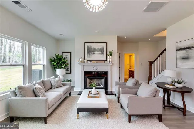 a living room with furniture and a fireplace
