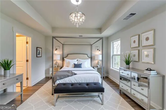 a bedroom with a bed and a chandelier