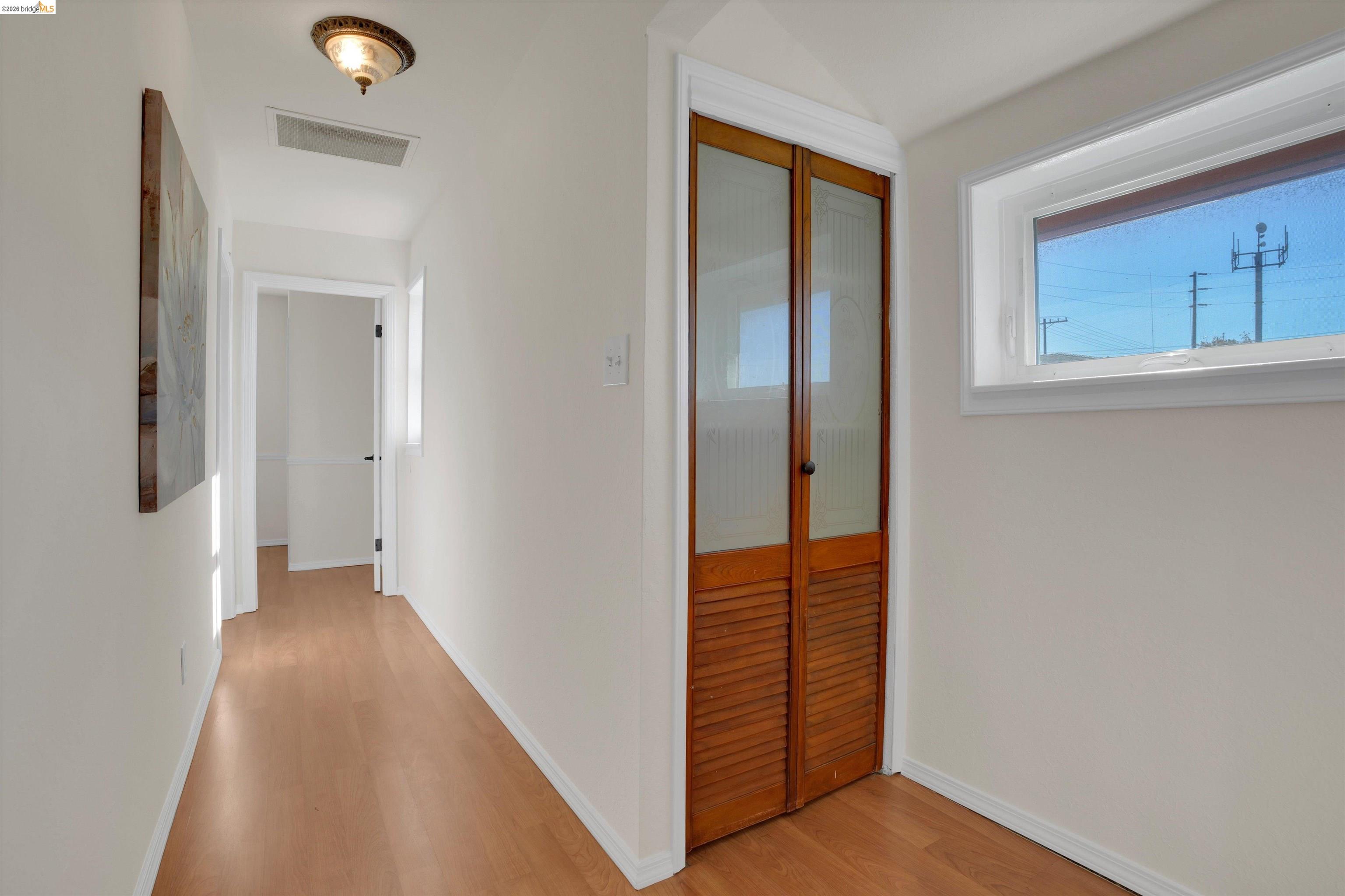 1821 Grand Street Alameda, CA 94501 - Photo 26 of 32 Hallway featuring light wood-style floors and baseboards