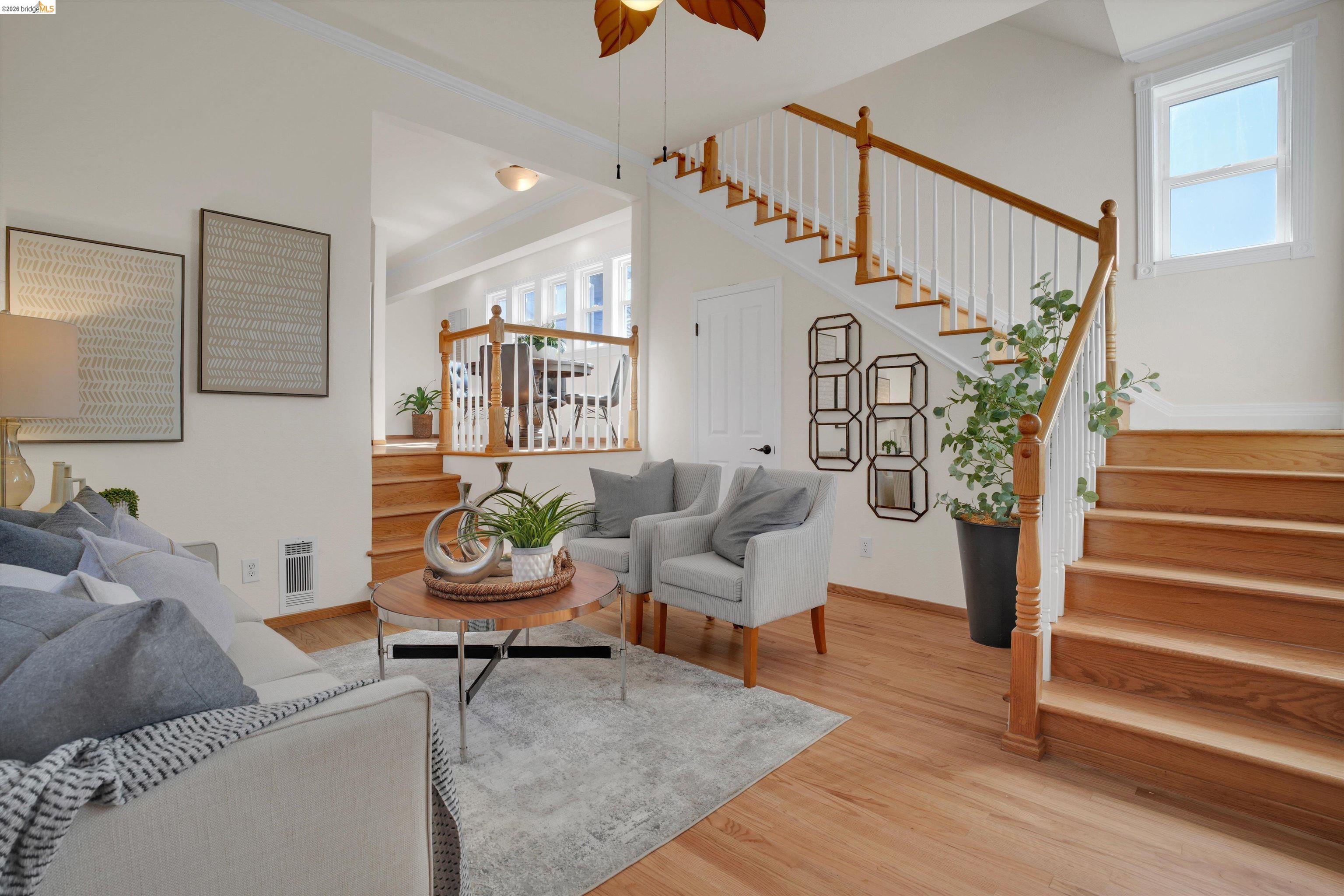 1821 Grand Street Alameda, CA 94501 - Photo 5 of 32 Living area featuring stairway, light wood-type flooring, ornamental molding, and a ceiling fan