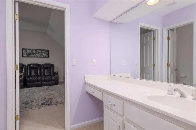 a bathroom with a granite countertop shower