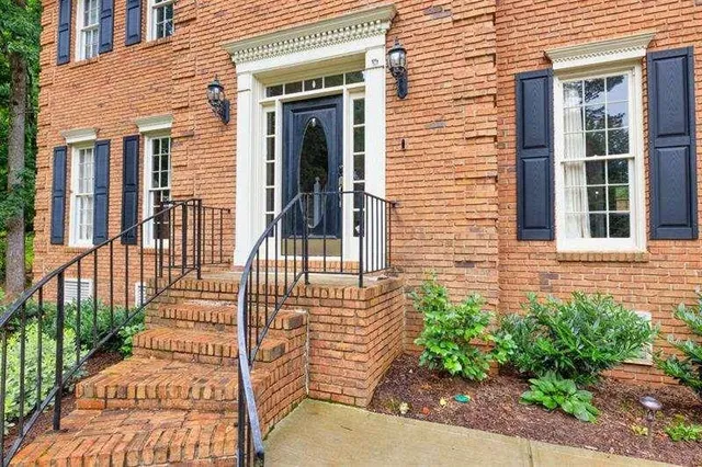 a view of a brick house with a large window