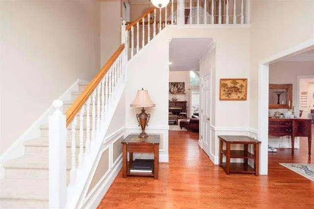 a view of entryway and hall with wooden floor