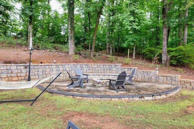 a view of a patio with table and chairs and floor to ceiling window