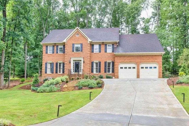a front view of a house with a yard