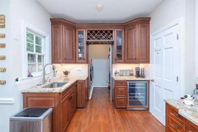 a large kitchen with stainless steel appliances granite countertop a lot of counter space and a sink