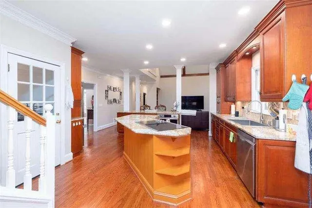 a large kitchen with stainless steel appliances granite countertop a sink and cabinets