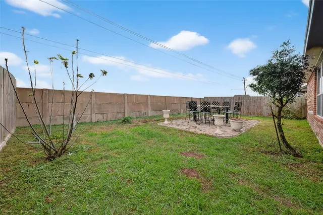 a view of a backyard with sitting area